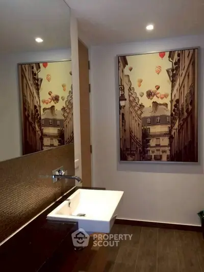 Stylish bathroom with modern sink and artistic wall decor