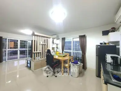 Modern open-layout kitchen and dining area with sleek design and ample natural light.