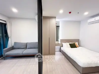 Modern studio apartment with cozy living area and stylish bedroom