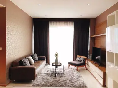 Elegant living room with modern furniture and natural light, perfect for relaxation and entertainment.