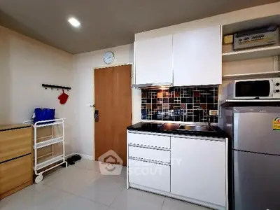 Modern kitchen with sleek cabinetry and stainless steel appliances in a compact layout.