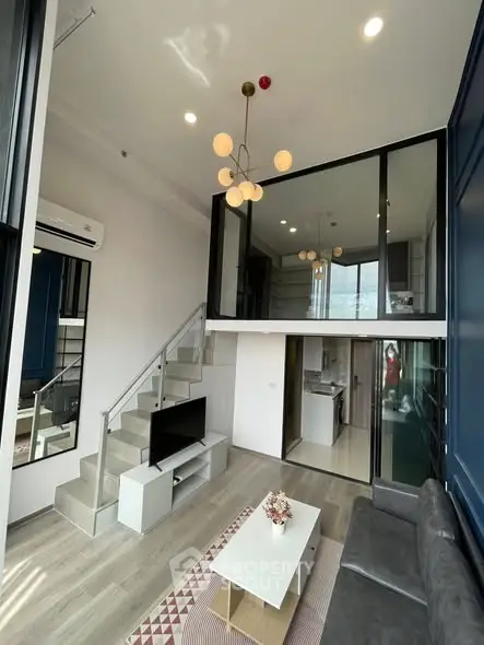 Modern loft apartment with high ceilings, stylish lighting, and open kitchen layout.