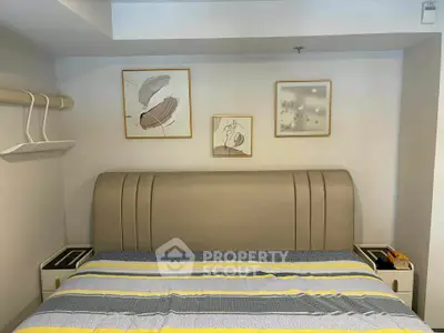 Cozy bedroom with modern decor and stylish artwork above the bed