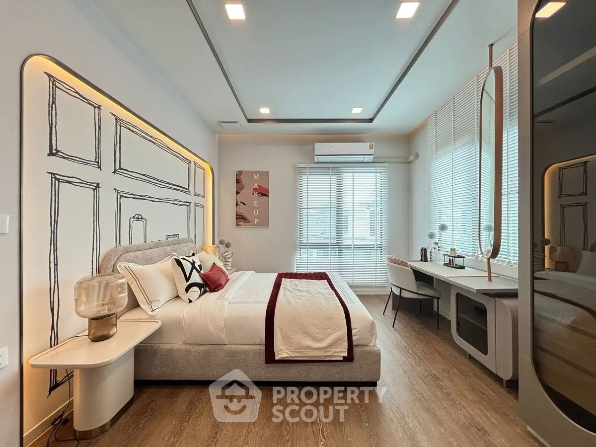 Luxurious modern bedroom with stylish decor and ample natural light.