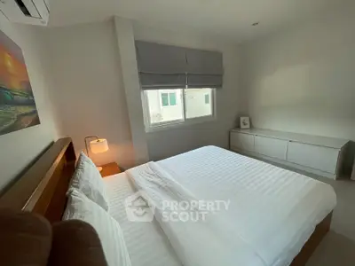 Cozy bedroom with modern decor and natural light, featuring a comfortable bed and stylish furnishings.