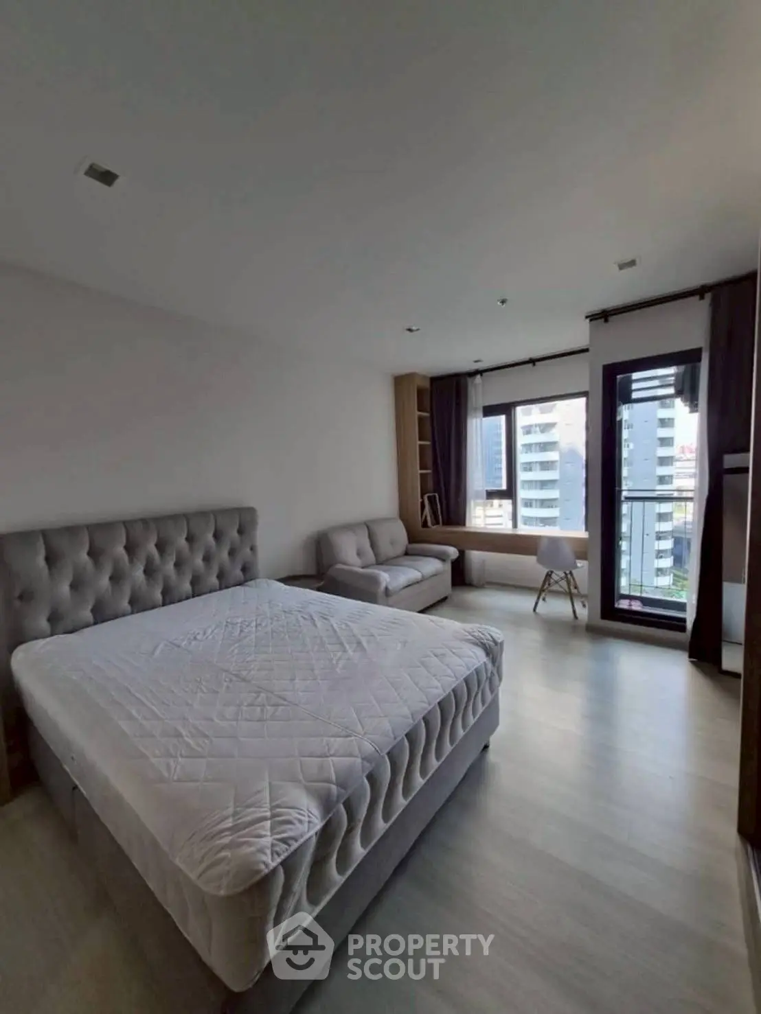 Spacious modern bedroom with city view and elegant furnishings