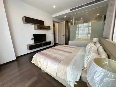Luxurious modern bedroom with elegant decor and large windows in a high-end apartment.