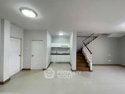 Spacious modern interior with sleek kitchen and elegant staircase