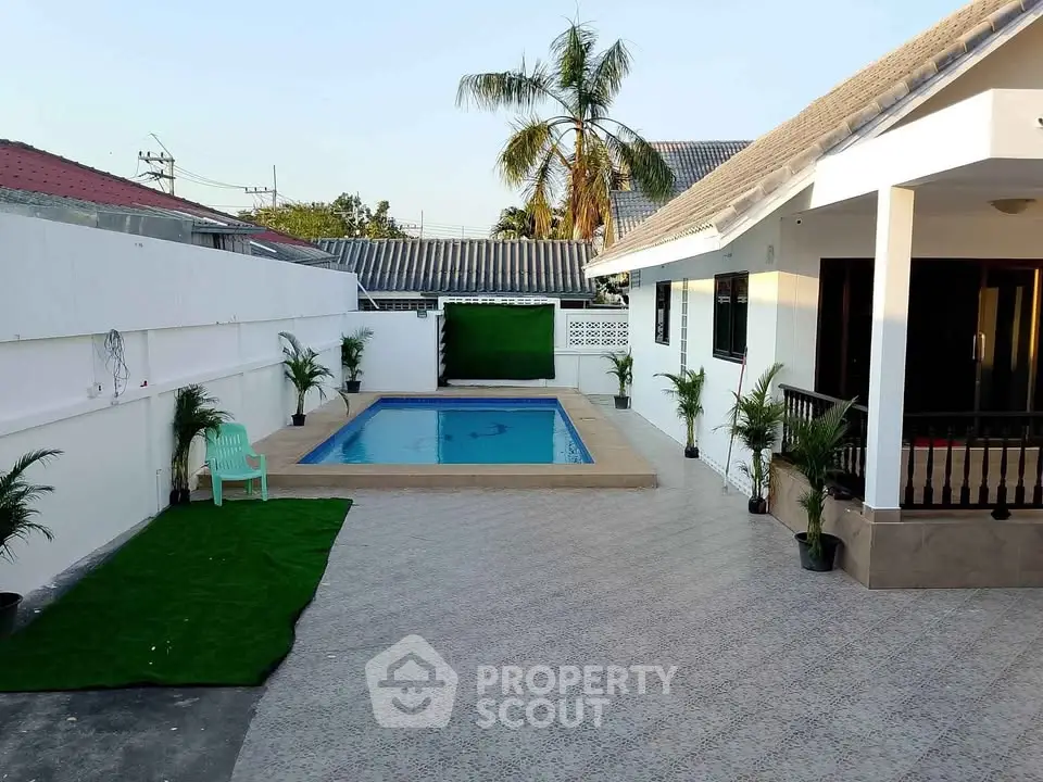 Spacious backyard with pool and modern patio in a serene residential area.