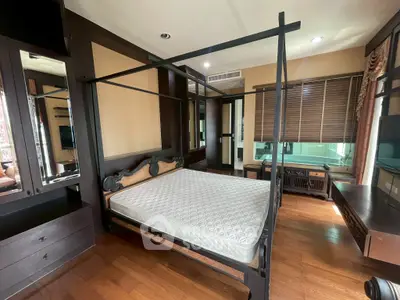 Luxurious bedroom with elegant dark wood furniture and large windows