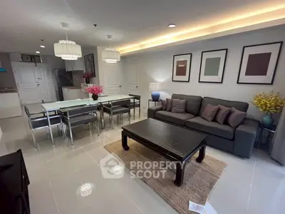 Spacious living room with modern decor and dining area, perfect for entertaining.