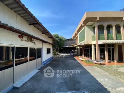 Spacious property with ample parking and unique architectural design, perfect for commercial or residential use.