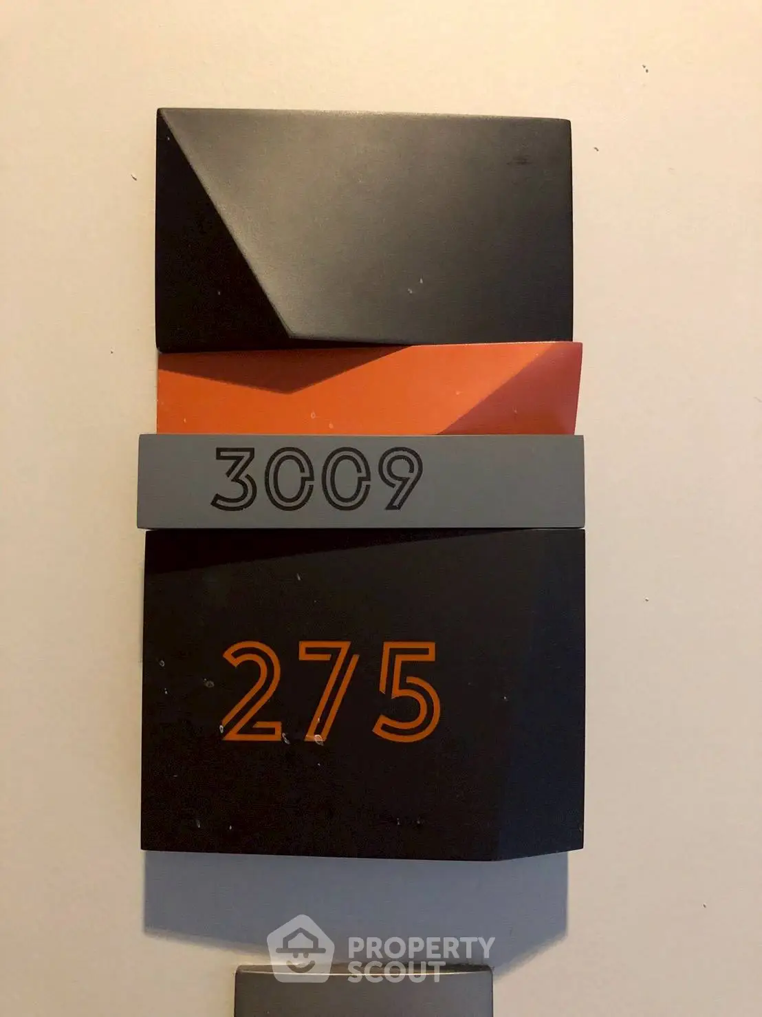 Modern apartment number sign with unique design and bold colors