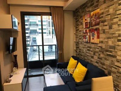 Modern living room with stylish decor and city view balcony access.