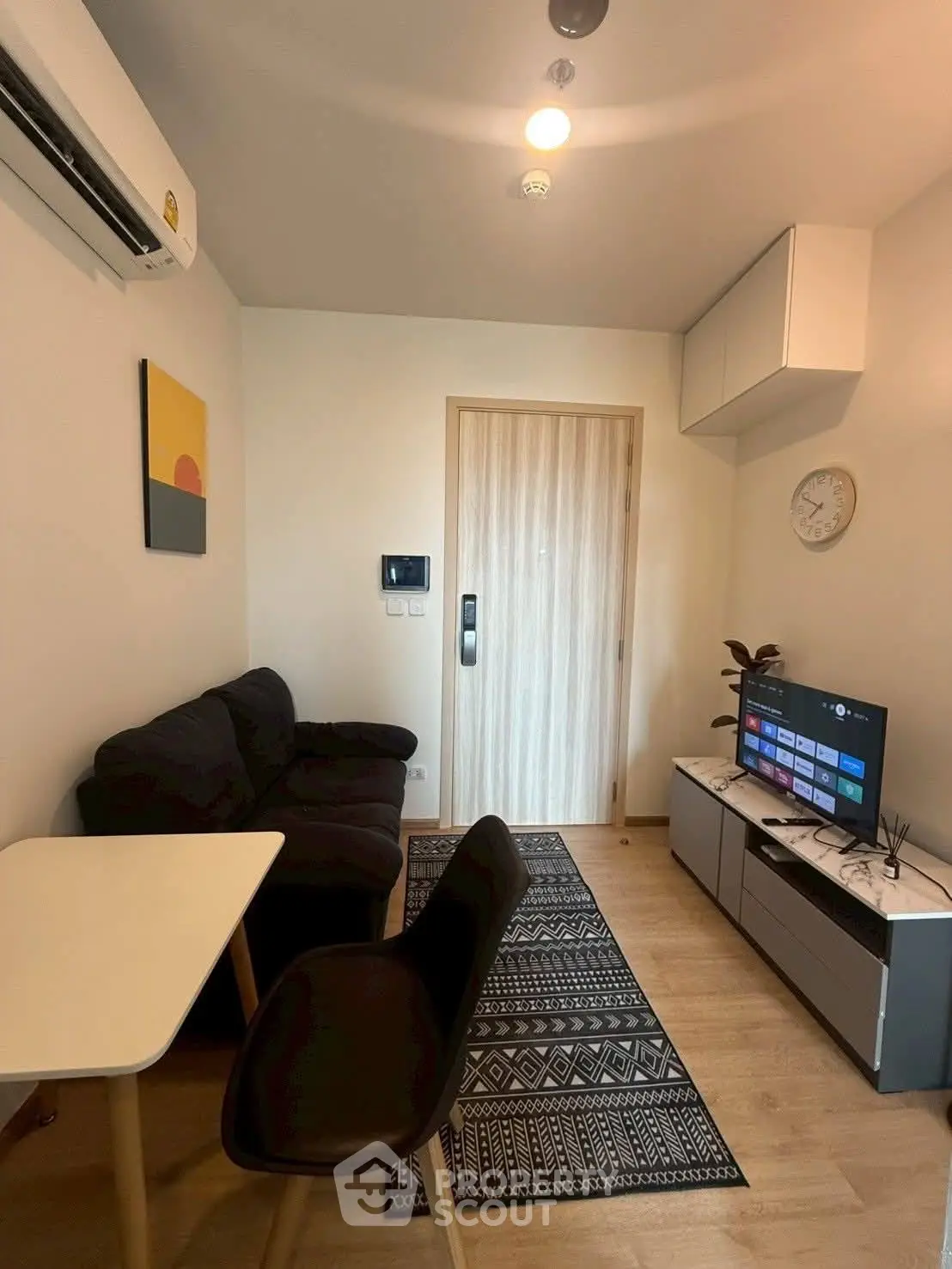 Cozy modern living room with stylish decor and smart TV setup.