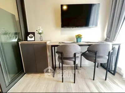 Modern study area with sleek furniture and wall-mounted TV in a stylish apartment.