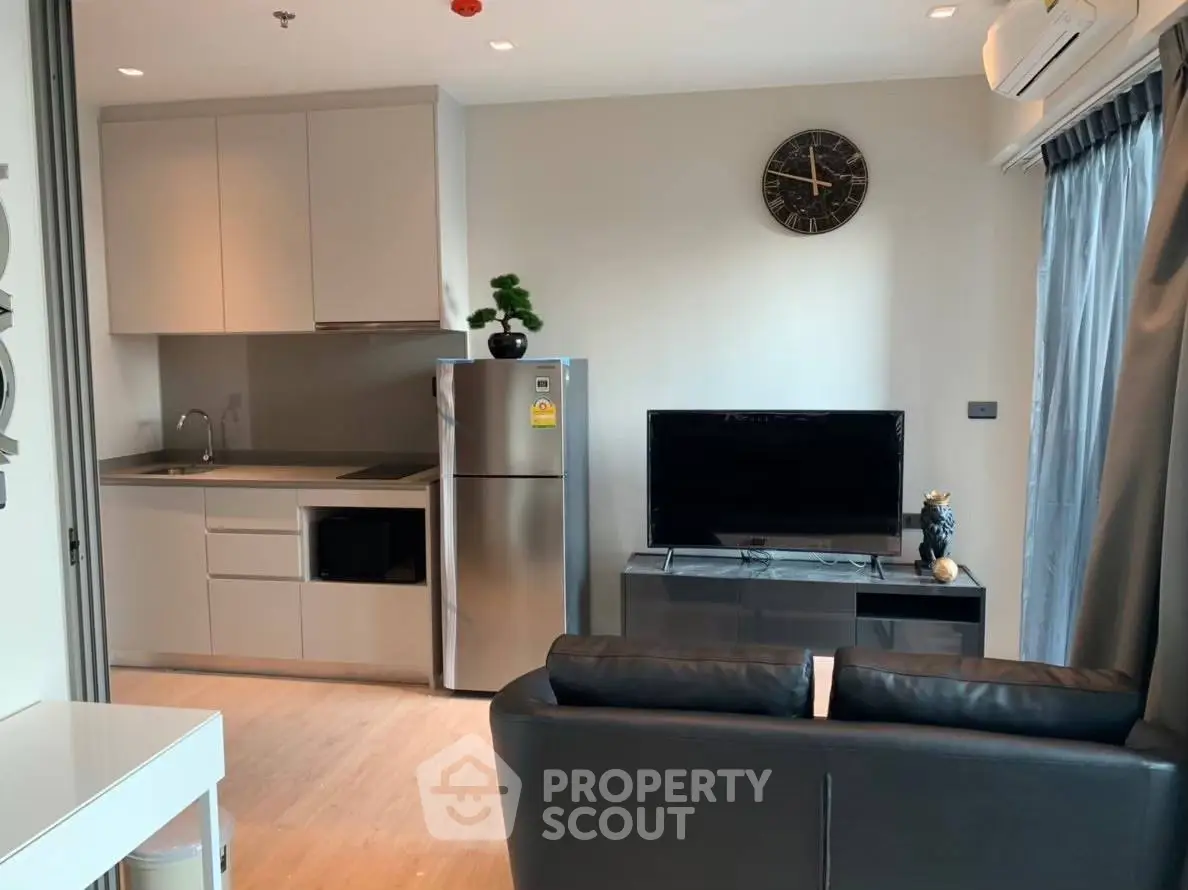 Modern living room with sleek kitchen and stylish decor