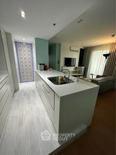 Modern open-layout kitchen with sleek design and living room view