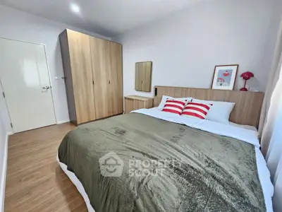 Modern bedroom with stylish decor and cozy ambiance, featuring a comfortable bed and wooden wardrobe.