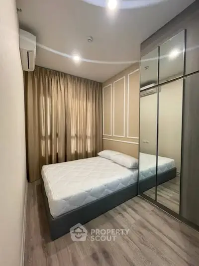 Modern bedroom with mirrored wardrobe and elegant curtains