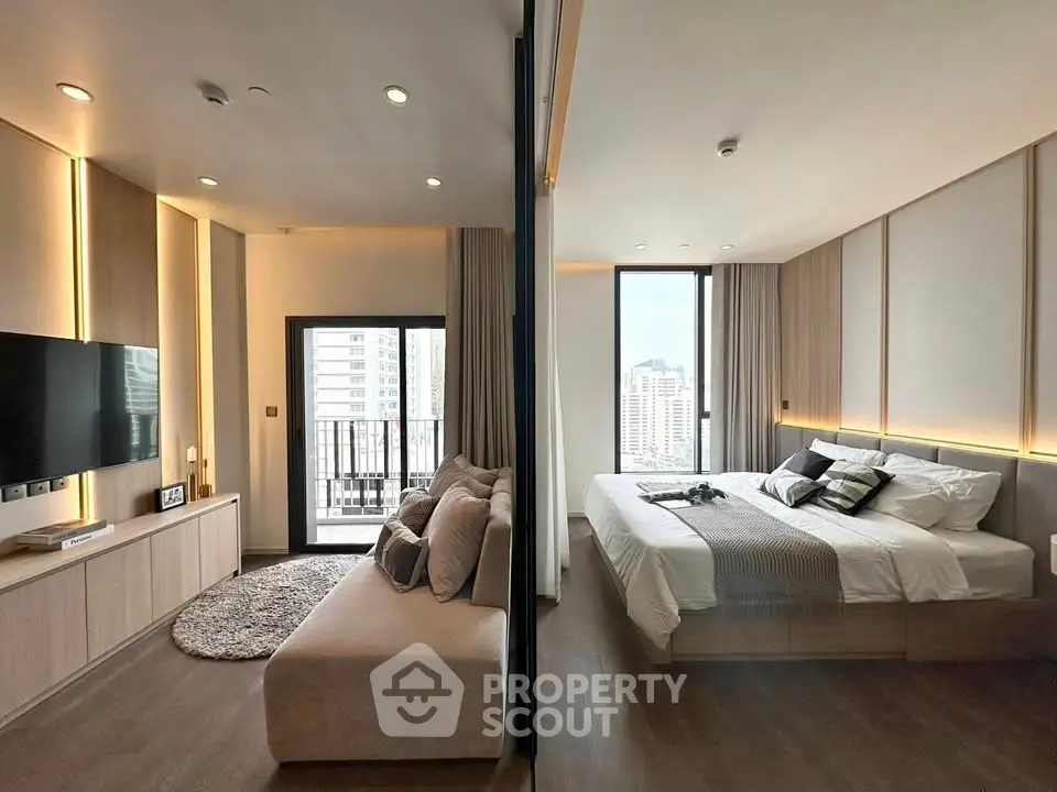 Modern apartment with spacious living room and cozy bedroom, featuring large windows and stylish decor.