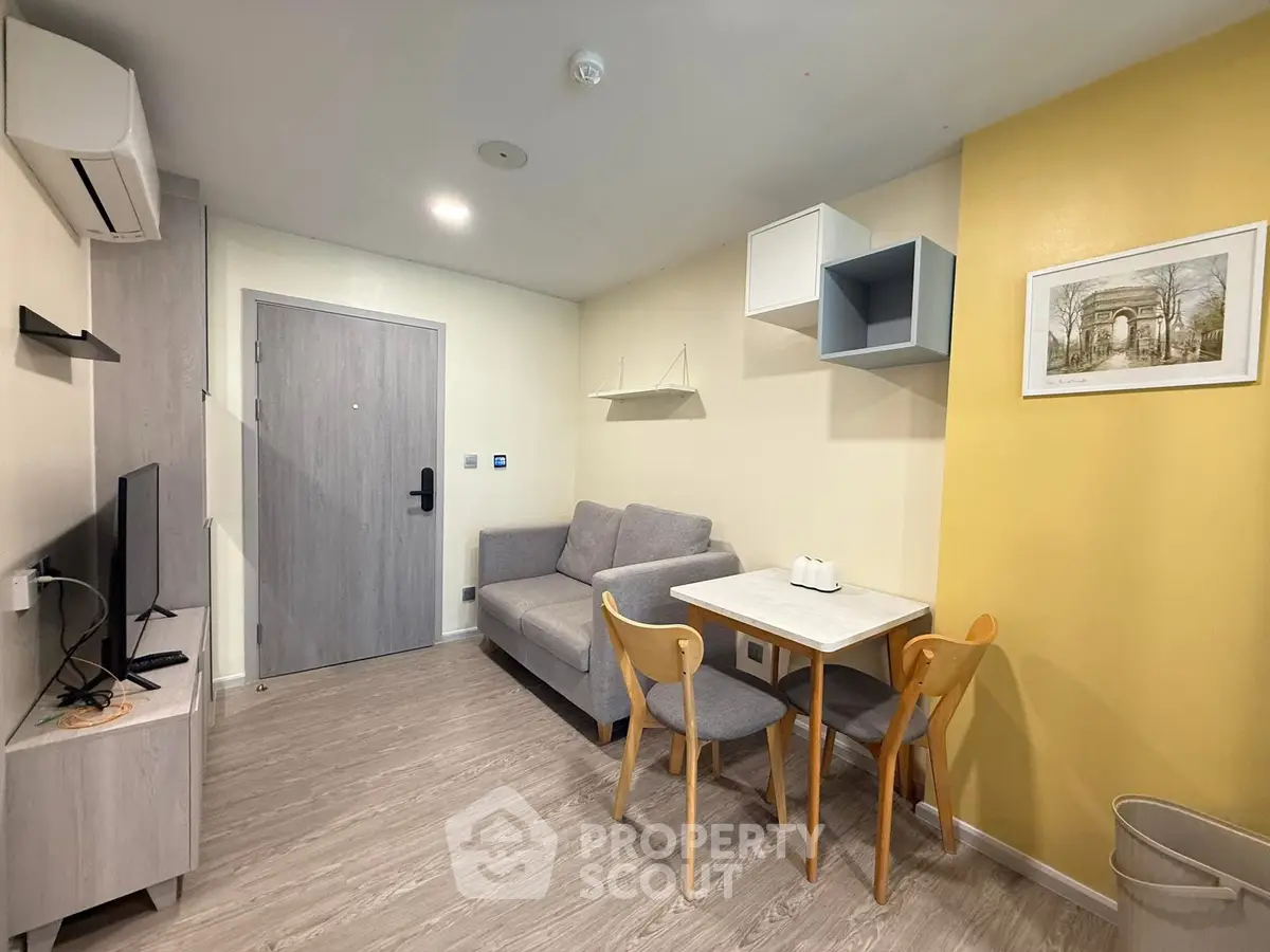 Modern living room with stylish furniture and wall art in a cozy apartment setting.