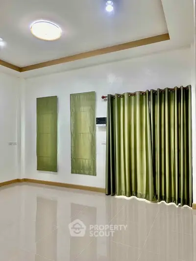 Spacious empty room with glossy tiled floor and green curtains, perfect for customization.