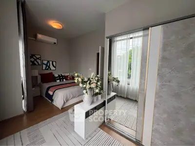 Modern bedroom with stylish decor and large mirrored wardrobe