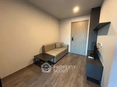 Modern living room with sleek furniture and wooden flooring