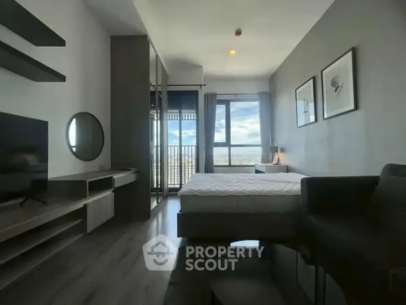 Modern bedroom with large window and stylish decor, offering a serene and comfortable living space.