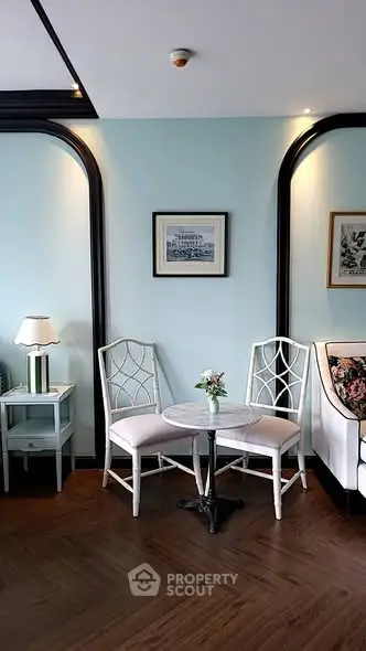 Charming living room corner with elegant chairs and table, perfect for cozy conversations.