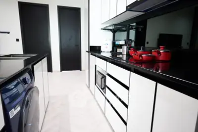 Modern kitchen with sleek black and white cabinetry and built-in appliances