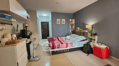 Cozy bedroom with modern decor and ample storage in a stylish apartment.