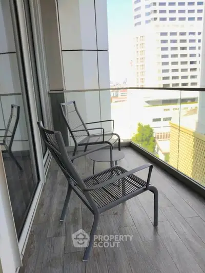 Modern balcony with city view and stylish seating, perfect for relaxation.