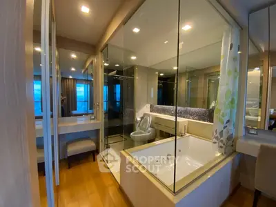 Luxurious bathroom with glass shower and modern bathtub in elegant apartment