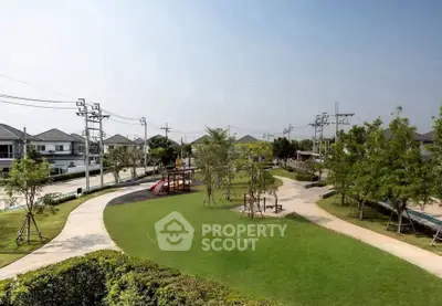 Beautiful residential park with lush greenery and playground in a serene neighborhood setting.