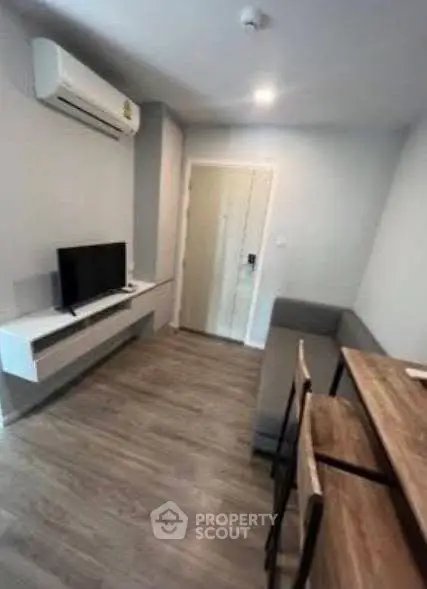 Modern living room with sleek furniture and air conditioning