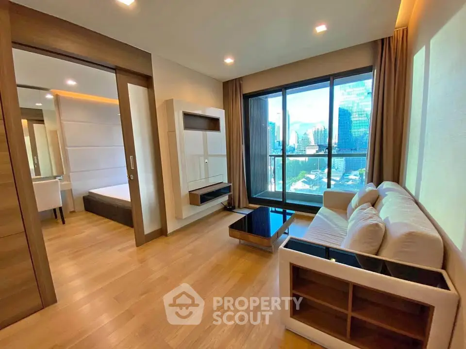 Modern living room with city view, wooden flooring, and stylish furniture in a high-rise apartment.