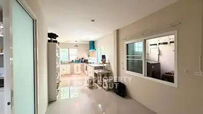 Spacious kitchen with modern appliances and open layout, perfect for culinary enthusiasts.