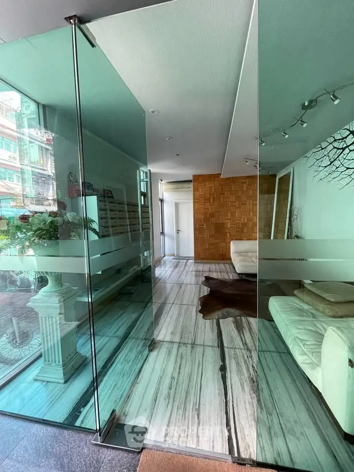 Modern interior with glass walls and stylish decor in a contemporary living space.