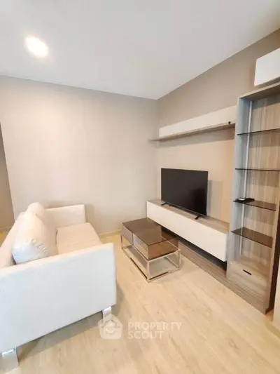 Modern living room with sleek furniture and neutral tones, perfect for relaxation and entertainment.