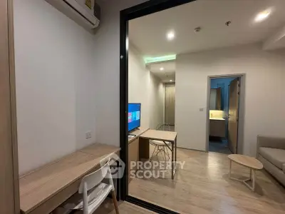 Modern studio apartment with sleek wooden furniture and open layout, perfect for urban living.