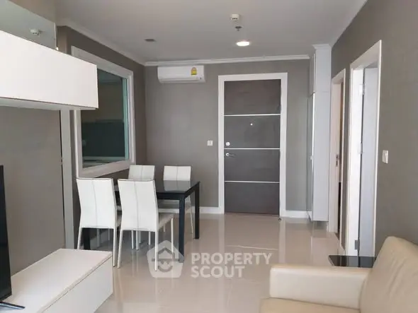 Modern living room with sleek dining area and neutral tones