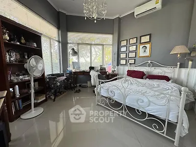Charming bedroom with elegant decor and large windows offering natural light.