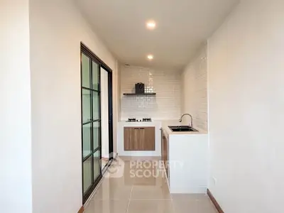 Modern kitchen with sleek design, featuring gas stove and ample counter space in a compact layout.