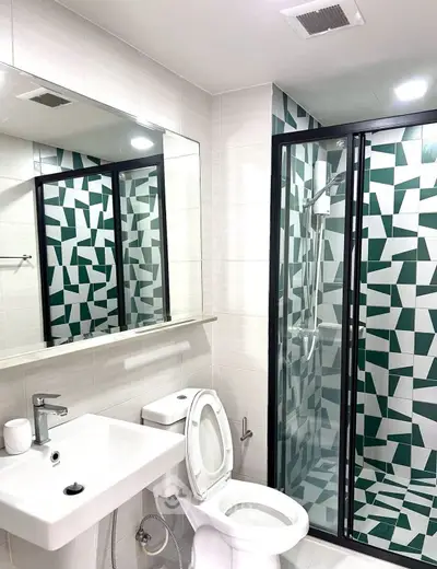 Modern bathroom with geometric tile shower and sleek fixtures