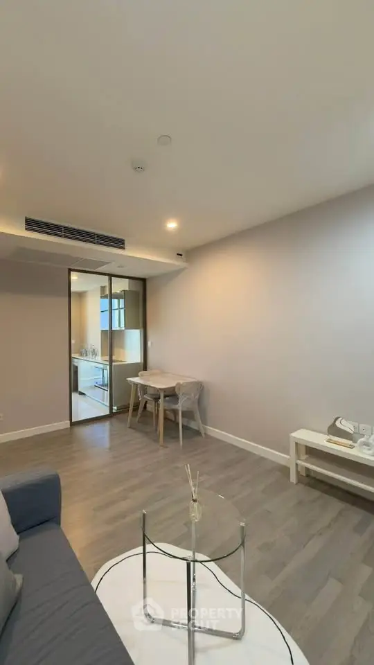 Modern living room with sleek design and open layout, featuring a cozy seating area and stylish decor.