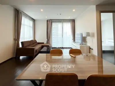Modern living room with stylish furniture and large windows offering natural light.
