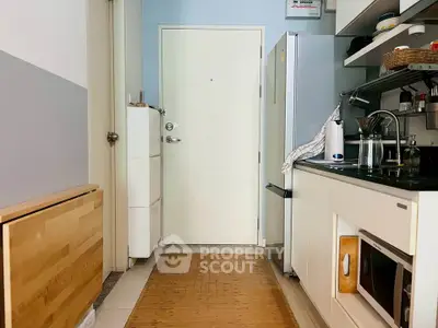 Compact kitchen with modern appliances and sleek design