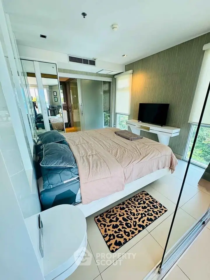 Modern bedroom with sleek design, large windows, and stylish decor in a high-rise apartment.